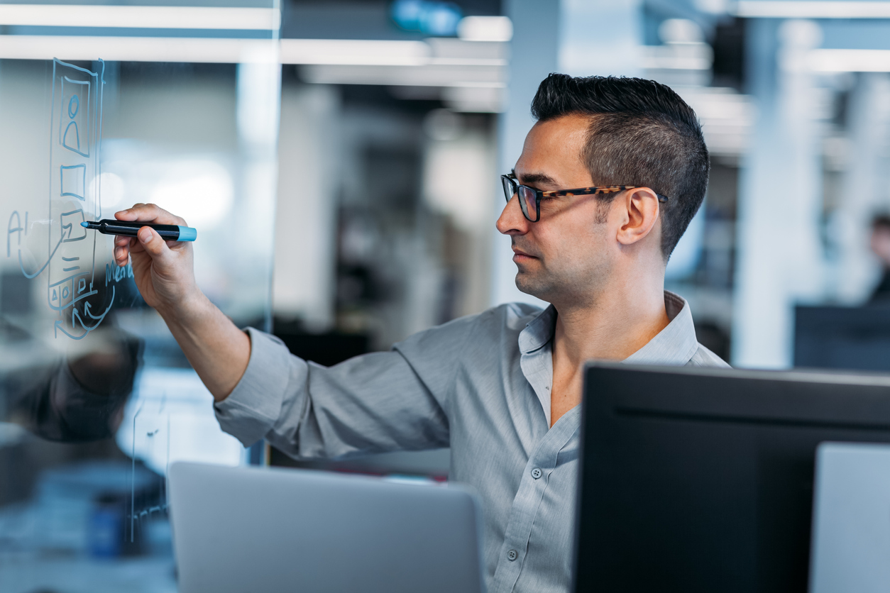 Person working on office white board